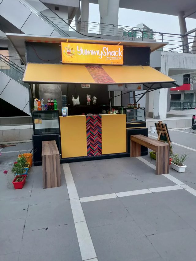Compact yellow and black YummyShack kiosk