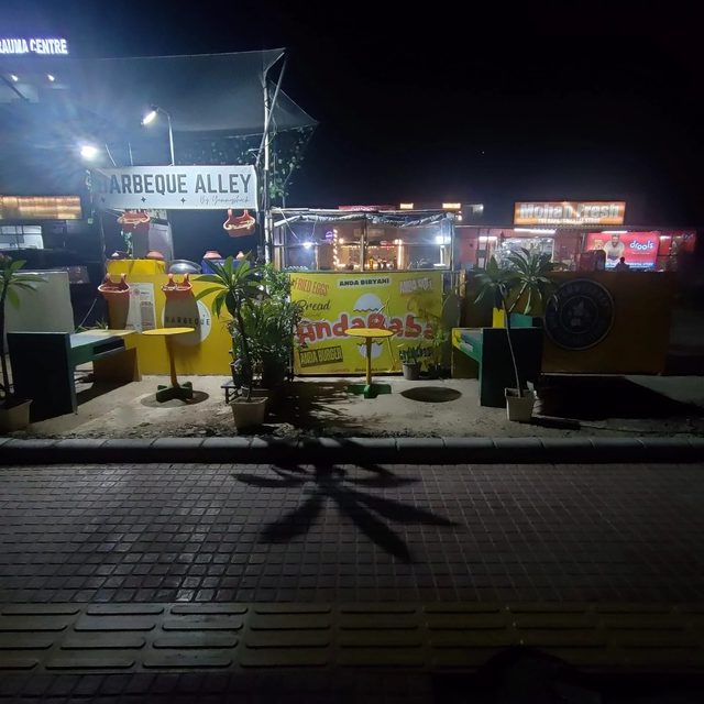 Planted neighbourhood food counter at night