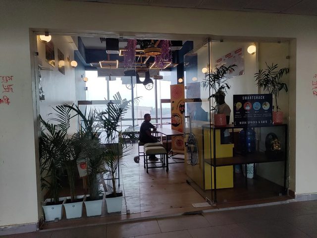 Indoor YummyShack café and workspace with plants and warm lights